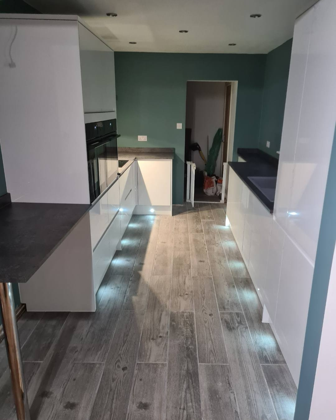 A modern kitchen with floor level lighting installed by J.R.O Home Renovations