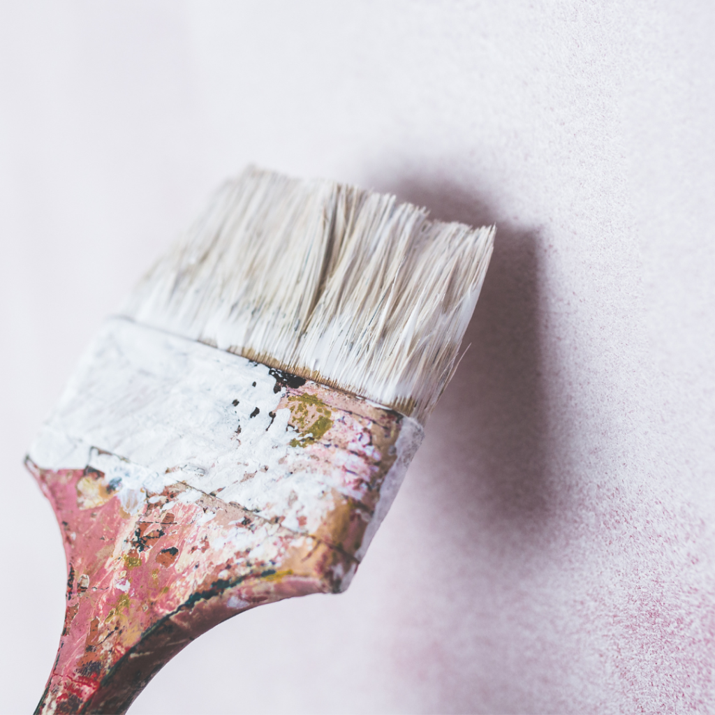 A paintbrush painting a wall
